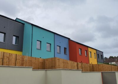 Closeboard fence in front of coloured houses